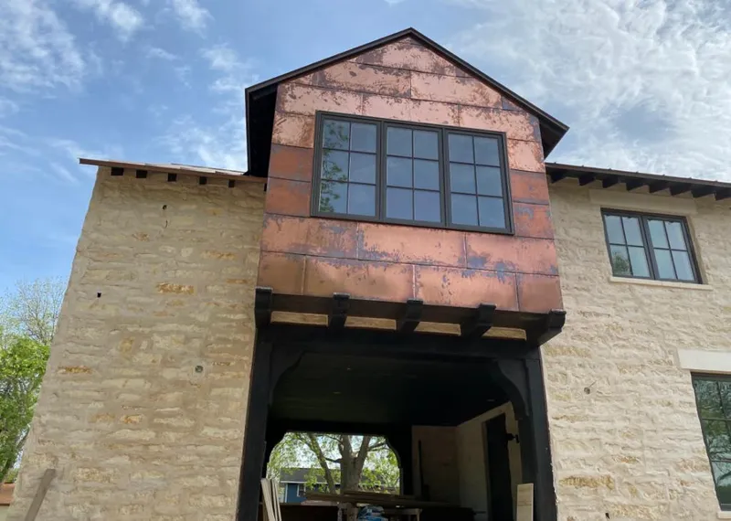 Copper metal panel facade on a stone building for Skylight Installation in Homestead